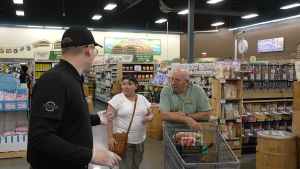 PTS field event with branded table and shoppers sampling products